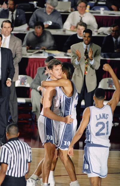 Duke's Christian Laettner, left, is hugged by teammate Grant Hill as the Blue Devils took the lead from Indiana in the second half of semifinal game Saturday, April 4, 1992 in Minneapolis. Celebrating at right is teammate Antonio Lang. Duke defeated India
