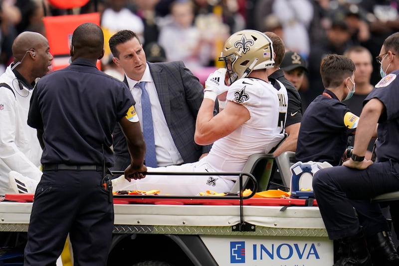 New Orleans Saints wide receiver Taysom Hill sits on a cart on the field in the first half of an NFL game against the Washington Football Team.
