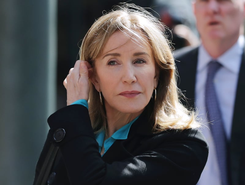In this April 3, 2019 file photo, actress Felicity Huffman arrives at federal court in Boston to face charges in a nationwide college admissions bribery scandal.