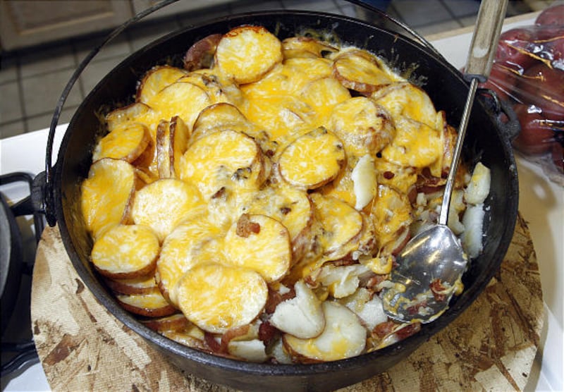 Dutch oven "Cowboy Potatoes" made by Roberts Family Farms with red potatoes, onions, cheese and bacon.