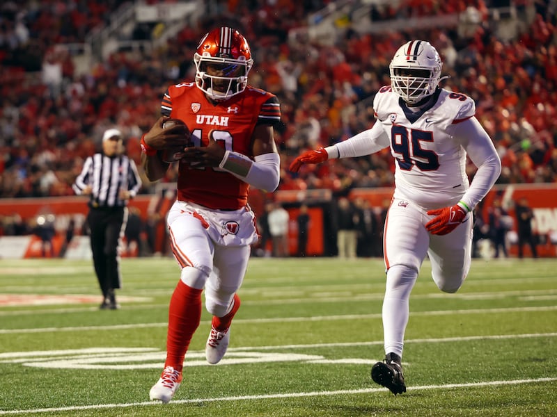 Utah Utes quarterback Nate Johnson takes the ball into the end zone vs. Arizona at Rice-Eccles Stadium.