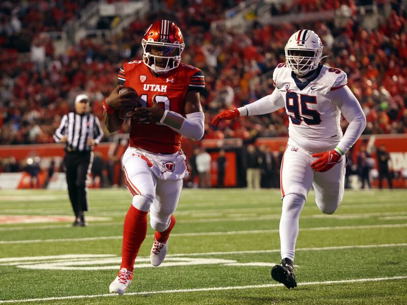 Utah Utes quarterback Nate Johnson takes the ball into the end zone vs. Arizona at Rice-Eccles Stadium.