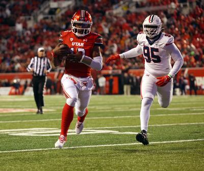 Utah Utes quarterback Nate Johnson takes the ball into the end zone vs. Arizona at Rice-Eccles Stadium.
