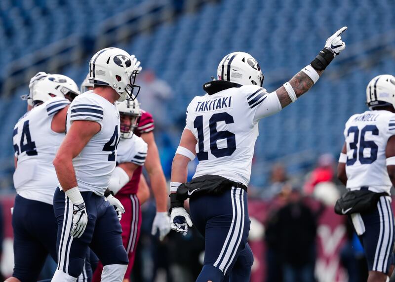 BYU's Sione Takitaki and teammates celebrate a play on Saturday.