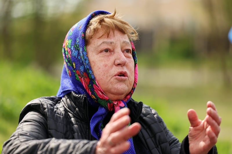 Maria Viktorovna Smaltser talks outside the Church of St. Andrew and Pyervozvannoho All Saints in Bucha, Ukraine.