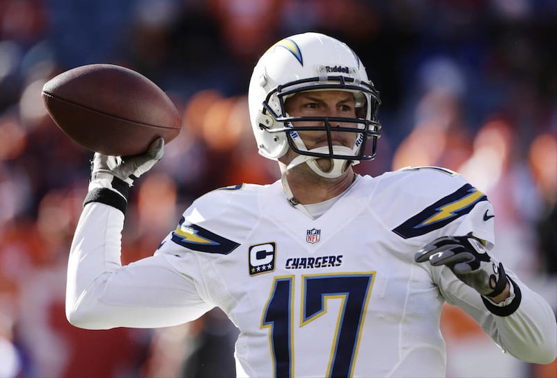 San Diego Chargers quarterback Philip Rivers warms up before playing against the Denver Broncos in an NFL AFC division playoff football game, Sunday, Jan. 12, 2014, in Denver.