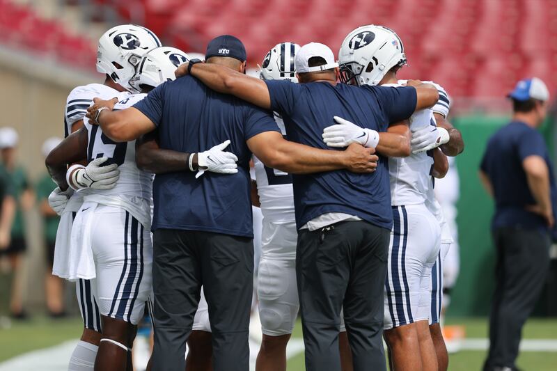 BYU players and coaches huddle up before BYU’s opener against USF on Sept. 3, 2022, at Raymond James Stadium in Tampa, Fla.