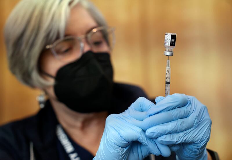 Community Nursing Services’ nurse Janie Wilson prepares a syringe of the Pfizer-BioNTech COVID-19 vaccine.