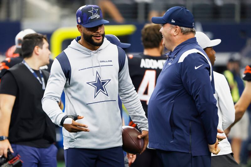An injured Dallas Cowboys quarterback Dak Prescott, left, talks with head coach Mike McCarthy, right, prior to a game Sunday, Sept. 18, 2022.