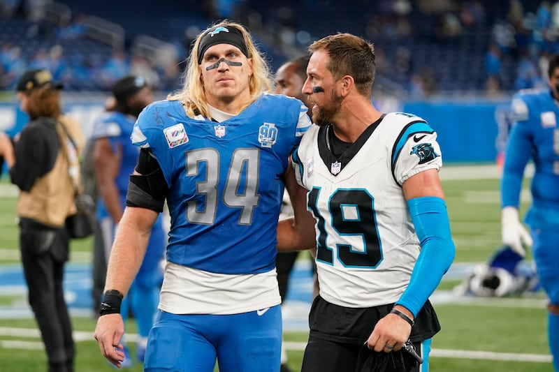 Detroit Lions linebacker Alex Anzalone (34) and Carolina Panthers wide receiver Adam Thielen (19) after a game, Oct. 8, 2023.