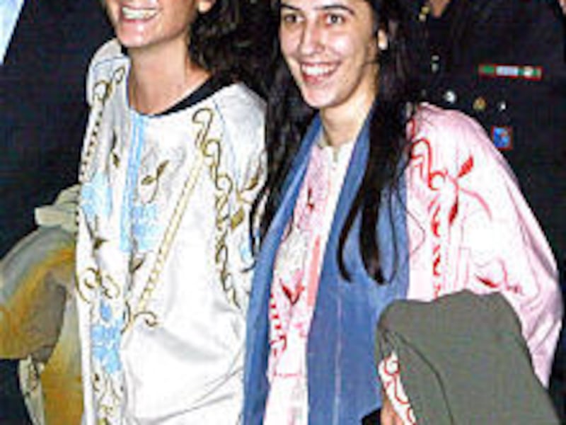 Simona Pari, left, and Simona Torretta arrive in Rome late Tuesday. The Italian women were kidnapped Sept. 7 in a raid on the Baghdad office of their aid agency.