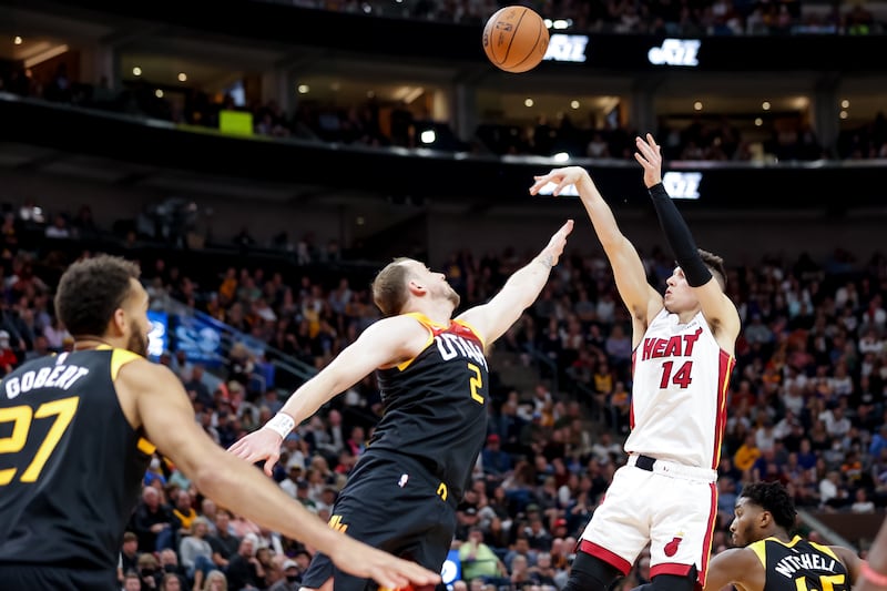 Miami Heat guard Tyler Herro (14) shoots over Utah Jazz guard Joe Ingles (2) during the game at Vivint Arena in Salt Lake City on Saturday, Nov. 13, 2021.