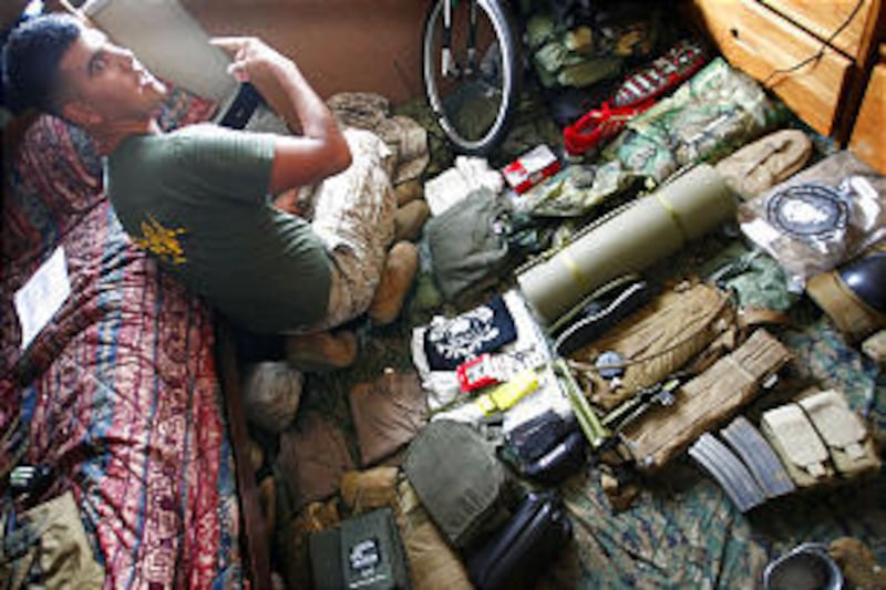 Cpl. Louis Baker from Port Huron, MI, of the 4th Combat Logistics Battalion (CLB-4) prepares his gear at the USMC Camp Foster in Okinawa islands, southwestern Japan earlier this month. The battalion is part of the largest deployment of Marines from Okinaw