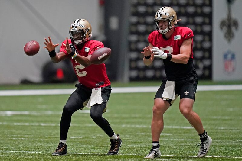 New Orleans Saints quarterbacks Jameis Winston (2) and Taysom Hill (7) go through drills during drills in Metairie, La.