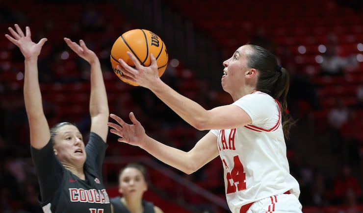 Utah Utes guard Kennady McQueen (wearing white) shoots over Washington State Cougars guard Astera Tuhina