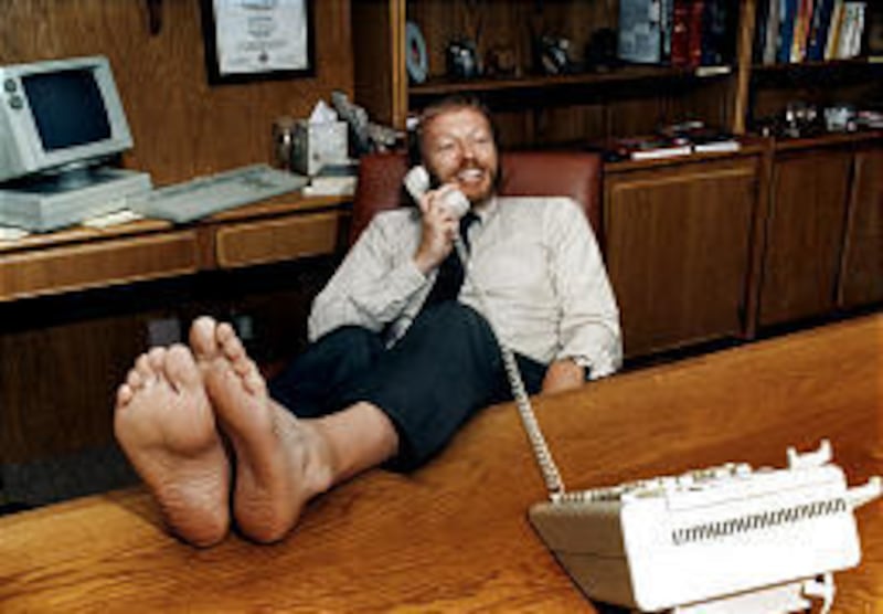 Phil Knight, founder of the world's largest shoemaker, works sans shoes in 1986.