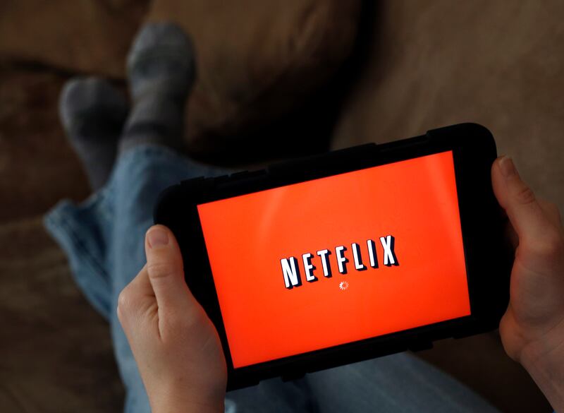 In this Friday, Jan. 17, 2014, file photo, a person displays Netflix on a tablet in North Andover, Mass.