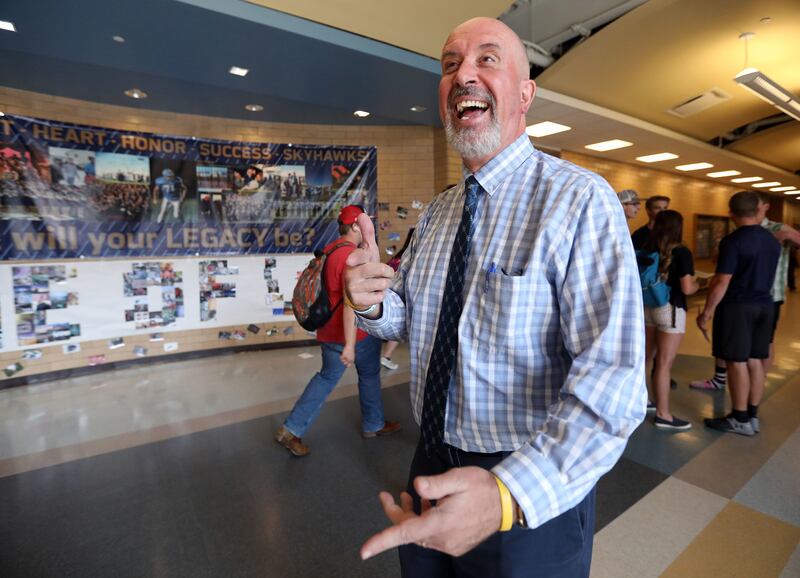 Principal Bart Peery talks to students as they walk by at Salem Hills High School in Salem on Thursday, May 24, 2018.