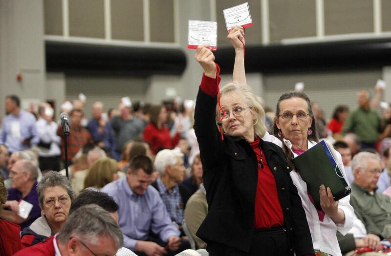 Janice Gerritsen, left, and Kathryn Fuller vote in favor of allowing five latecomers to be credentialed as delegates at the Salt Lake County GOP convention at the Salt Palace Convention Center in Salt Lake City on Saturday, April 14, 2012.