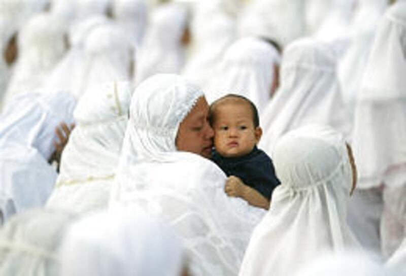 A woman holds a child after Eid al-Adha prayer in the tsunami-ravaged town of Meulaboh in the Aceh province of Indonesia on Friday.