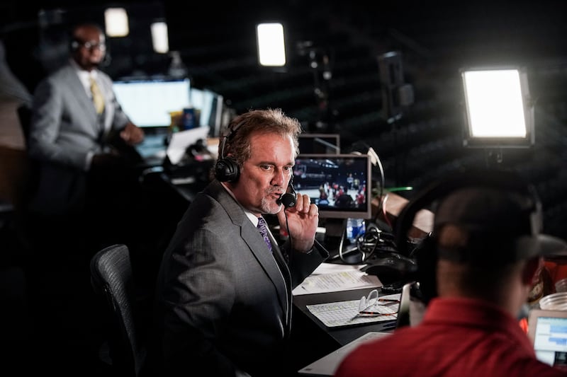 Craig Bolerjack, wearing a suit and tie, calls the play-by-play.