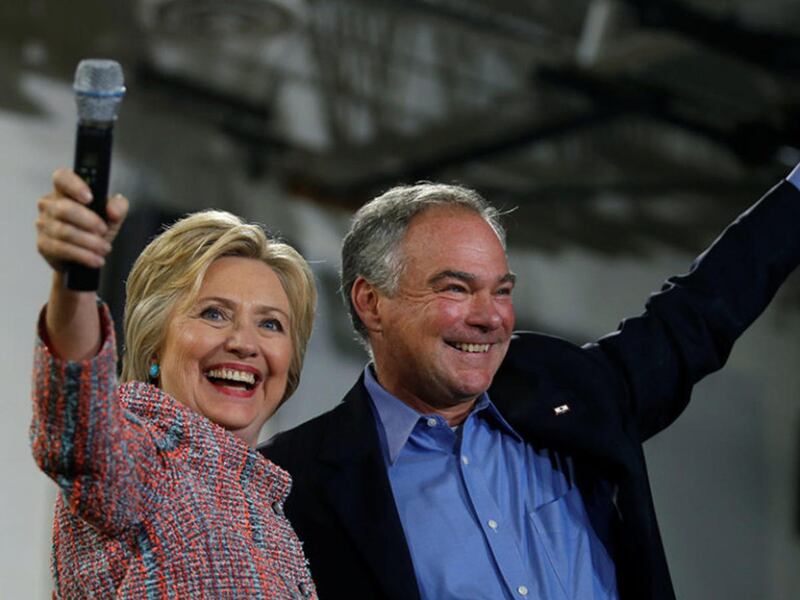 Democratic presidential candidate Hillary Clinton and U.S. Sen. Tim Kaine, D-Va., wave to the crowd during a campaign rally at Ernst Community Cultural Center in Annandale, Va., on July 14, 2016.