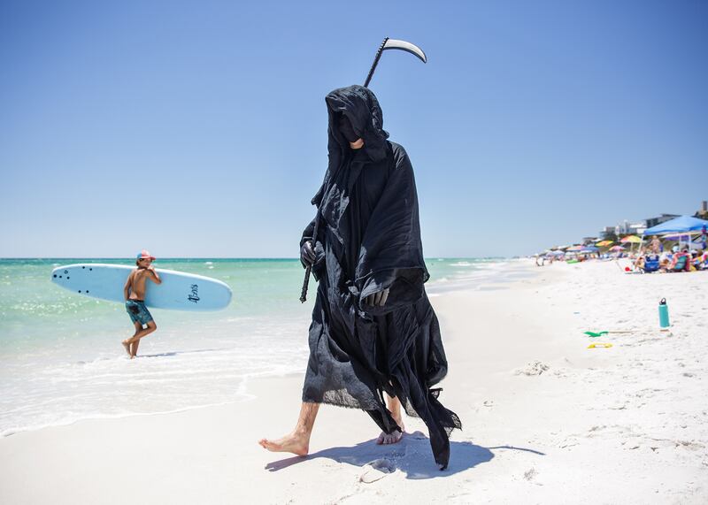 Daniel Uhlfelder, the grim reaper of Florida’s Panhandle, stalks the shoreline in his home of Walton County on May 1, 2020. He plans to make appearances at beaches across the state, having started with Pensacola on May 8.