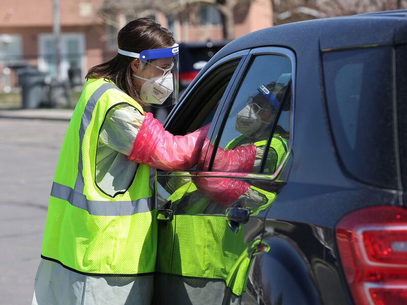 Brittaney Bailey tests a person for COVID-19 in West Valley City.