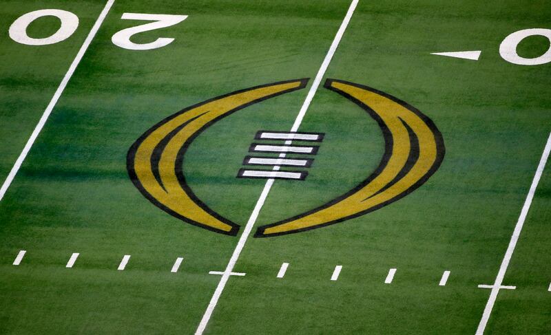 The College Football Playoff logo is shown on the field at AT&T Stadium before the Rose Bowl between Notre Dame and Alabama.