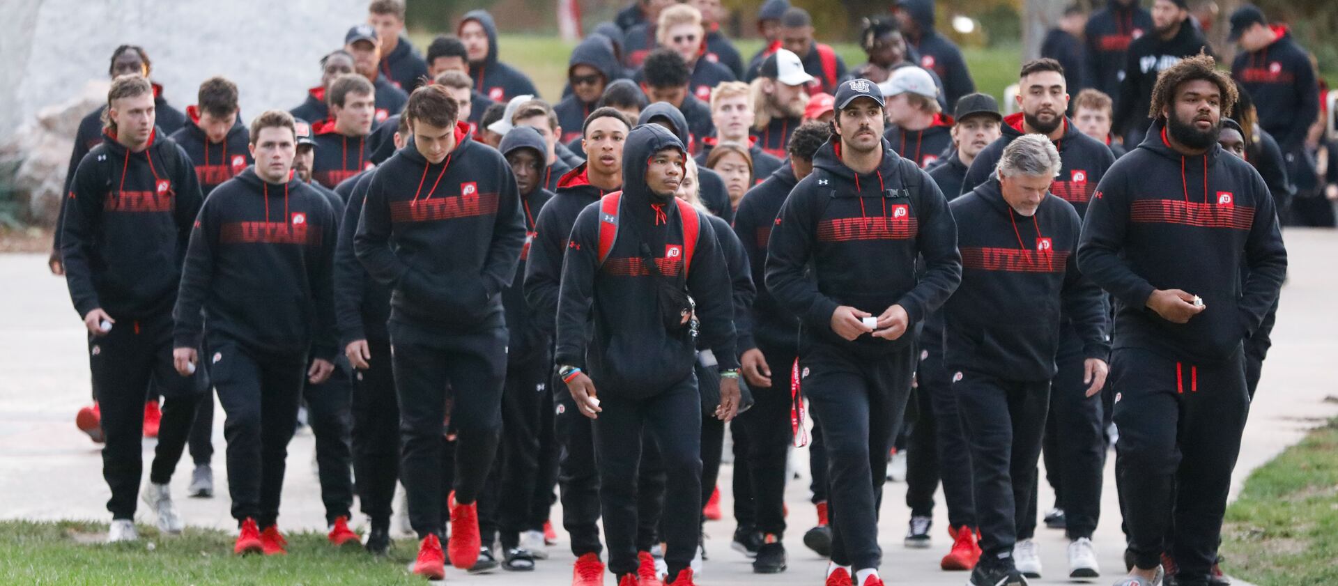 University of Utah football players arrive to a candlelight vigil remembering the life of slain student-athlete Aaron Lowe.