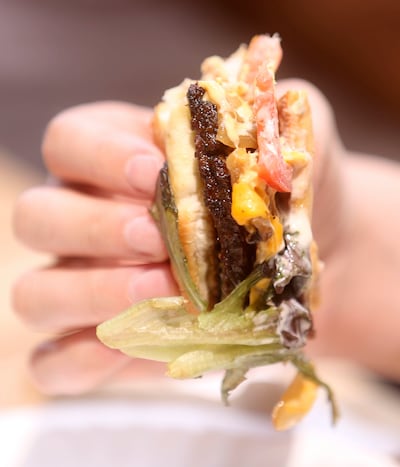A taste tester eats a burger at the Deseret News office in the Triad Center in Salt Lake City on Tuesday, Aug. 6, 2019.