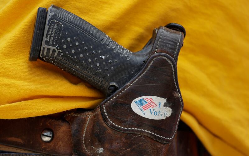 FILE - In this April 14, 2018 file photo, a man wears an unloaded pistol during a pro gun-rights rally in Austin, Texas. A House committee will hold its first hearing on gun violence in years. Two other panels will gavel in hearings on climate change. Thr
