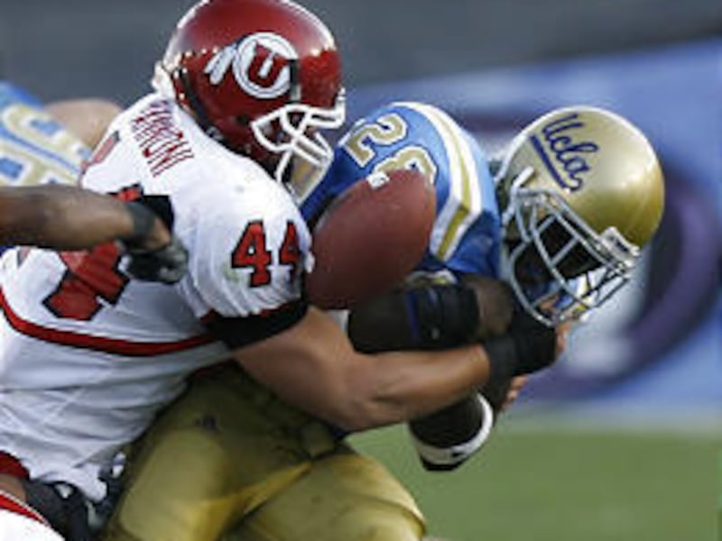 Utah's Joe Jiannoni pops the ball loose from UCLA's Chris Markey during the Utes' first game of the season in the Rose Bowl.