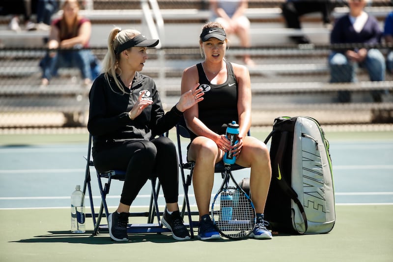 Lauren Jones-Spencer (left) coaches Anastasia Abramyan (right) on the sideline.