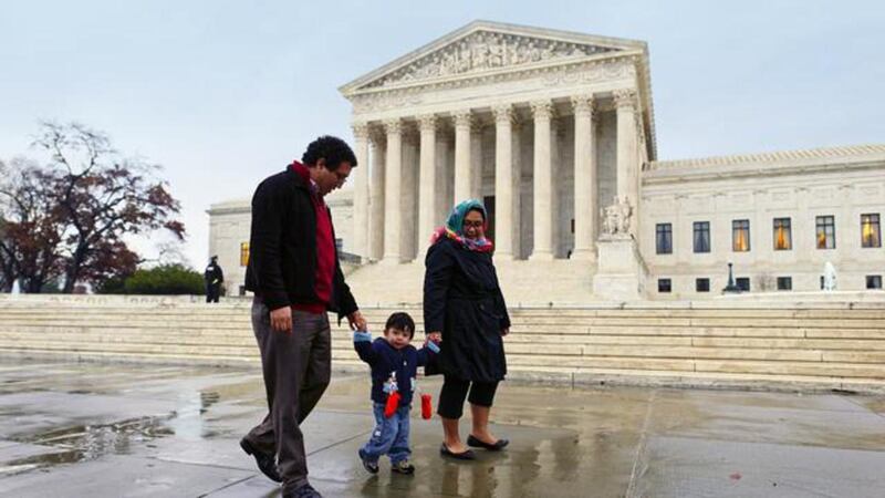 A family walks outside the United States Supreme Court.