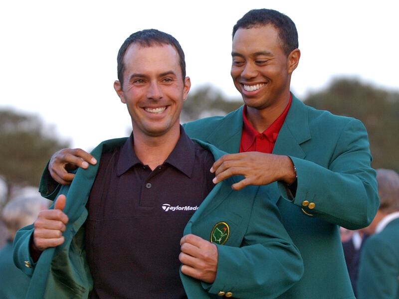 2002 champion Tiger Woods, right, helps Mike Weir don the traditional Green Jacket at the 2003 Masters, at Augusta National.