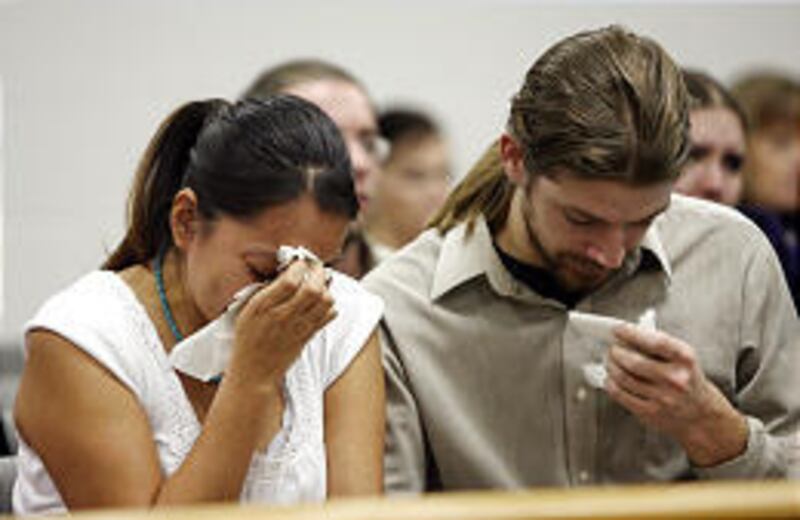 Sharon Zahne, left, the mother of a girl who was brutally assaulted in 2002, cries with family friend Mike Vance at parole hearing. They urged the Board of Pardons and Parole to keep the attacker in prison.