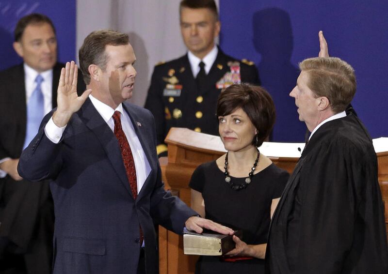 This Jan. 7, 2013 file photo shows Utah Attorney General John Swallow, left, being sworn in by Chief Justice Matthew B. Durrant, right, at the Utah Sate Capitol Rotunda, in Salt Lake City. With nothing coming from the federal investigation so far and new