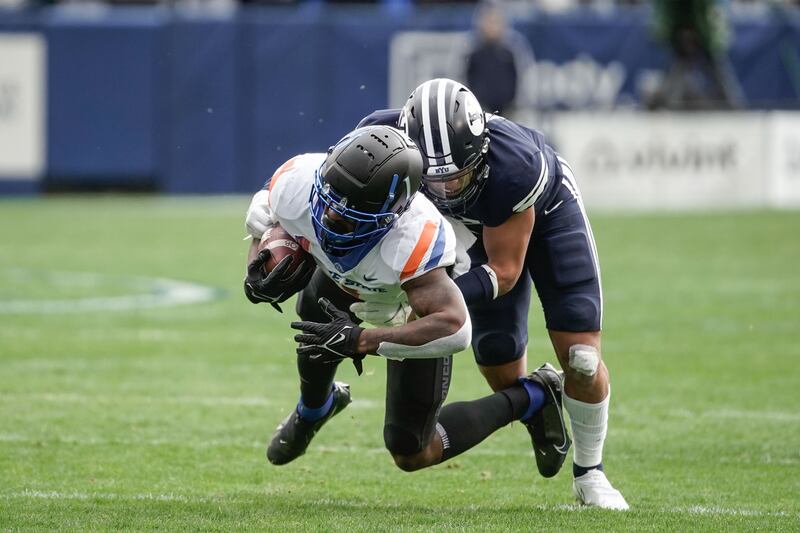 Boise State receiver Octavius Evans gets tackled by BYU safety Chaz Ah You during game in Provo on Saturday, Oct. 9, 2021.