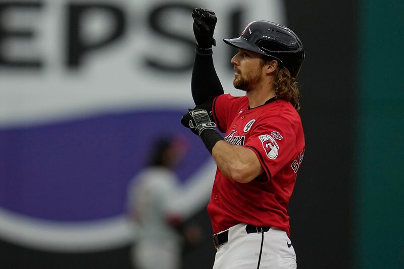 Cleveland Guardians' Daniel Schneemann gestures from first base after his first Major League hit, a double, against the Washington Nationals Sunday, June 2, 2024, in Cleveland.
