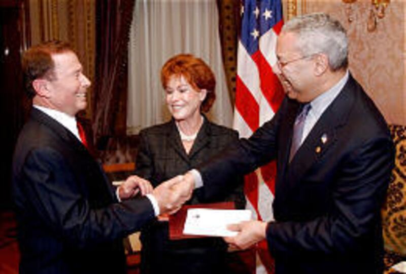 John Price, left, with wife Marcia and Colin Powell in '02, must pay $6.5 million to former business partners.