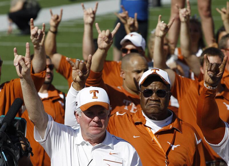 Texas coach Mack Brown, front left, takes part in the school song following an NCAA college football game against Texas Tech, Saturday, Nov. 5, 2011, in Austin, Texas. The fate of a Longhorn player's eligibility is in BYU's hands, as a BYU Independent Stu