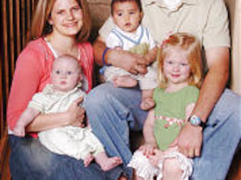 Alisha Doman holds Jace; Brandon holds Isaac (a k a Siaosi) and Sage.