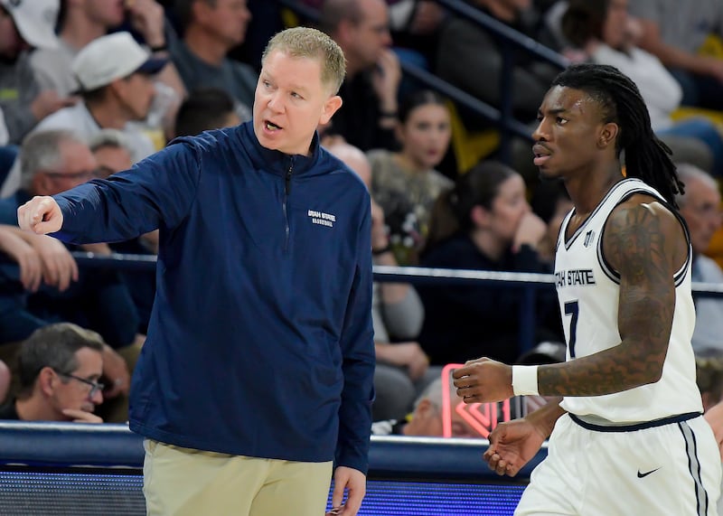 Utah State head coach Jerrod Calhoun talks to guard Kolby King (7) on Saturday, Nov. 15, 2025, in Logan.
