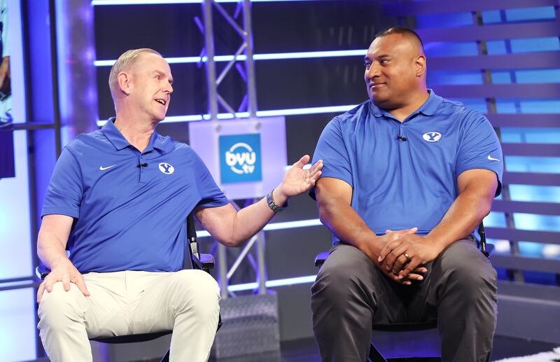 BYU athletic director Tom Holmoe, left, and head football coach Kalani Sitake talk during a broadcast BYU football media day.