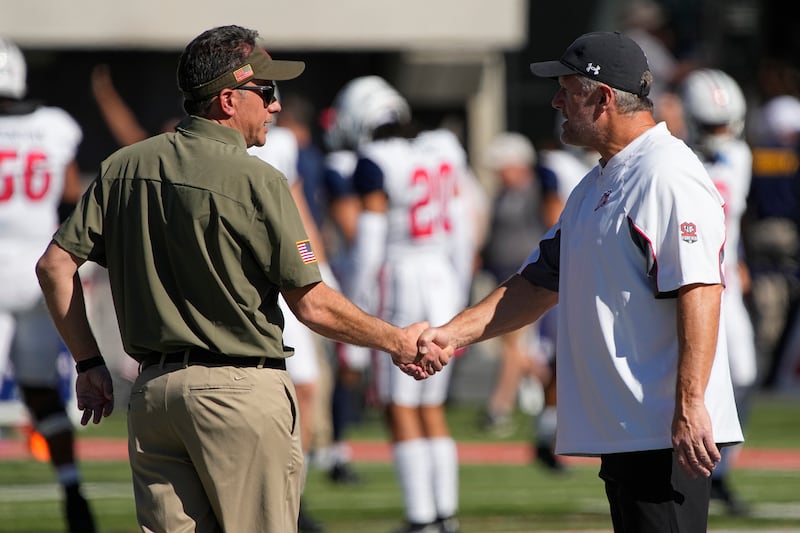 Arizona head coach Jedd Fisch, left, and Utah head coach Kyle Whittingham talk before a Pac-12 game on Nov. 13, 2021, in Tucson, Ariz.