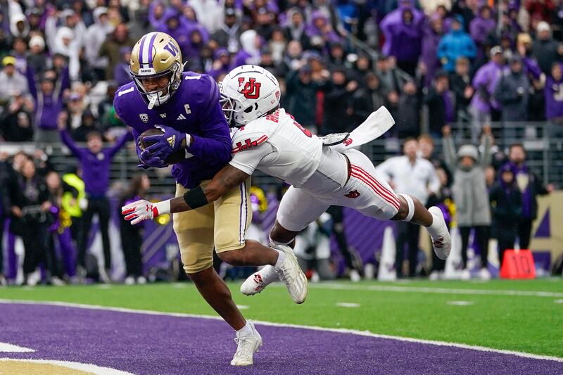 Washington wide receiver Rome Odunze (1) makes a catch for a touchdown against Utah cornerback JaTravis Broughton (4) during the second half of an NCAA college football game Saturday, Nov. 11, 2023, in Seattle. Washington won 35-28.