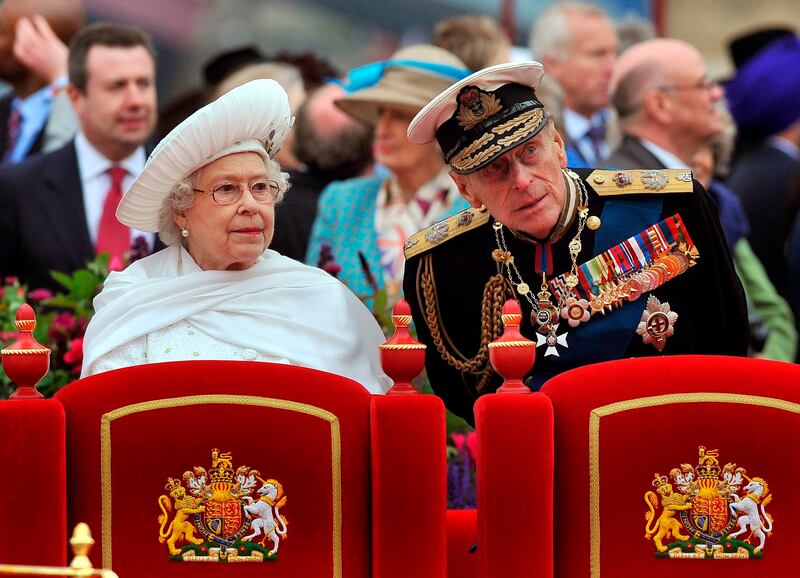 A Sunday June 3, 2012 photo from files showing Britain’s Queen Elizabeth II, and her husband Prince Philip watching the proceedings from the royal barge during the Diamond Jubilee Pageant on the River Thames in London.
