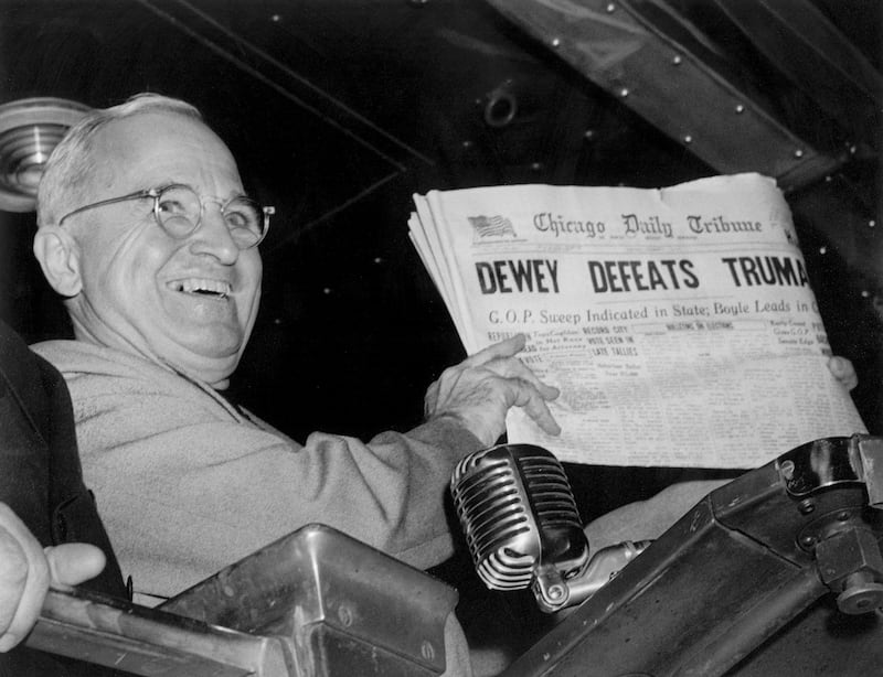 In this Nov. 4, 1948, file photo, President Harry S. Truman holds up an election day edition of the Chicago Daily Tribune, which, based on early results, mistakenly announced “Dewey Defeats Truman.”