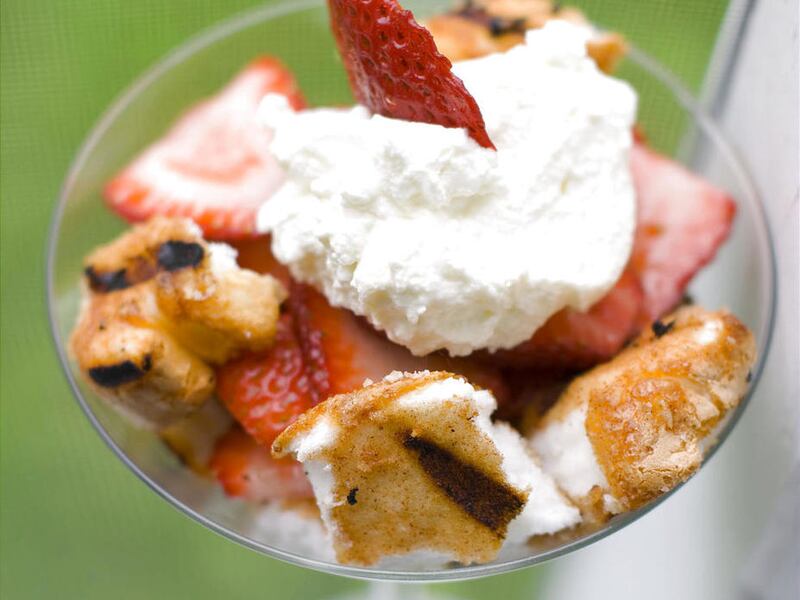 This May 30, 2012 image shows a dessert of spiced and grilled angel food cake with strawberries and whipped cream in Concord, N.H. Now people are whipping more than just cream, they’re whipping all their favorite drinks.